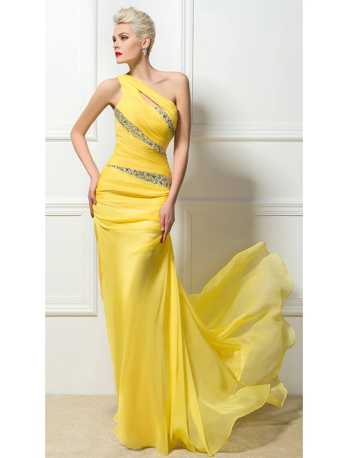 Woman in an elegant light-colored one-shoulder ruched sequin evening gown with a sweep train.