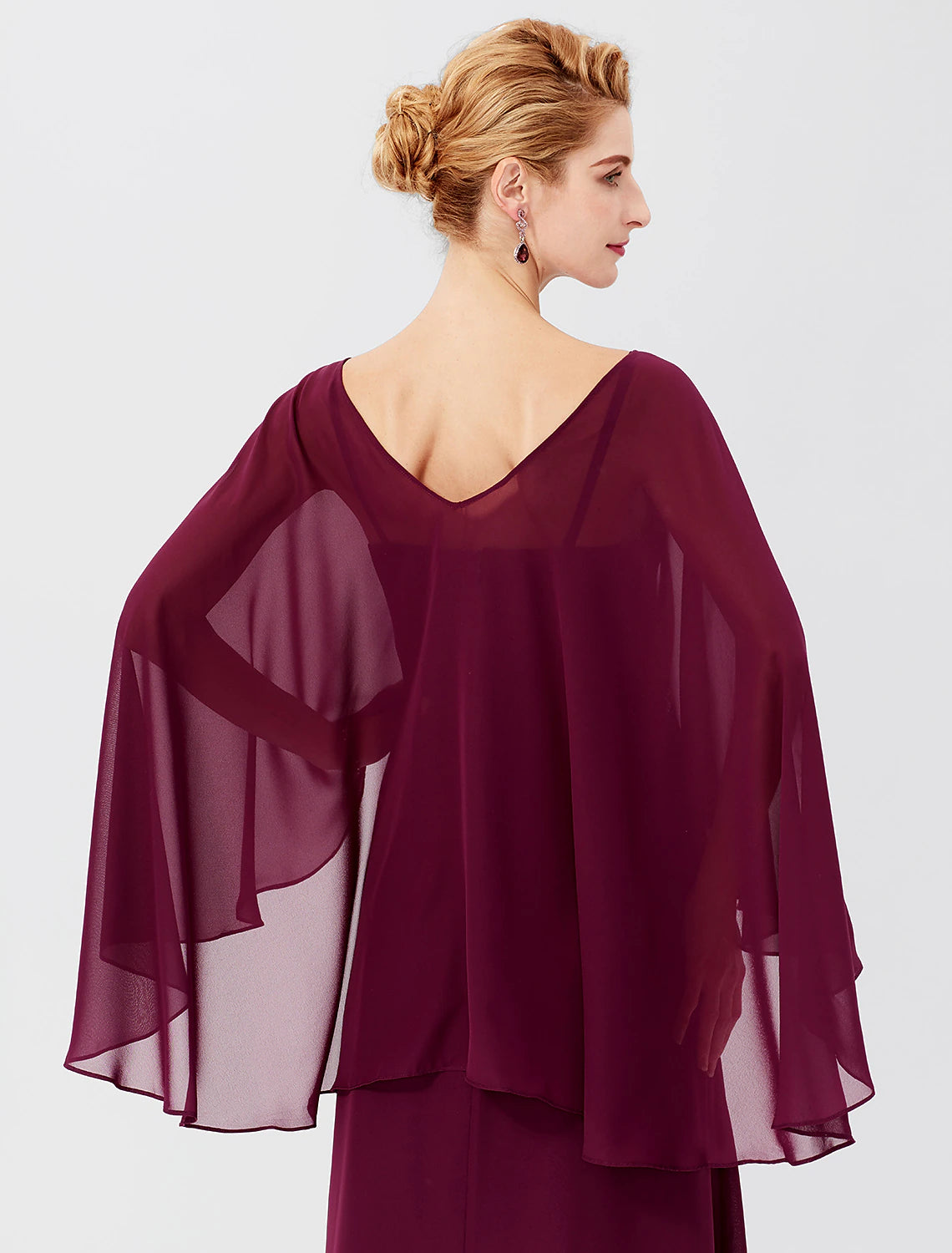 Close-up of the V-neckline, long sleeves, and beaded details on the dress.