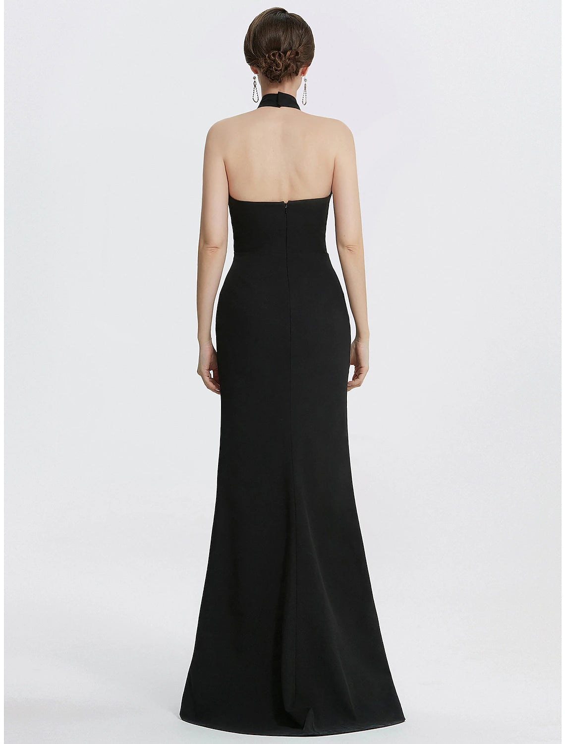 Side view of model in a Weitese black halter neck ruched sheath evening gown.