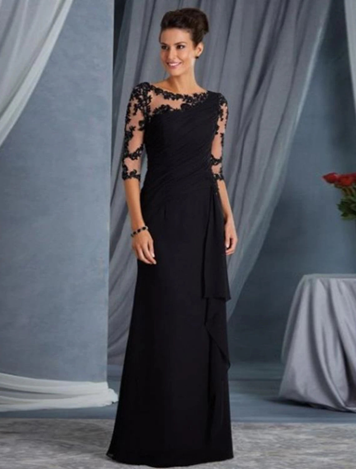 Woman wearing a Weitese elegant black sheath evening gown with jewel neck and half sleeves, featuring lace and appliques.