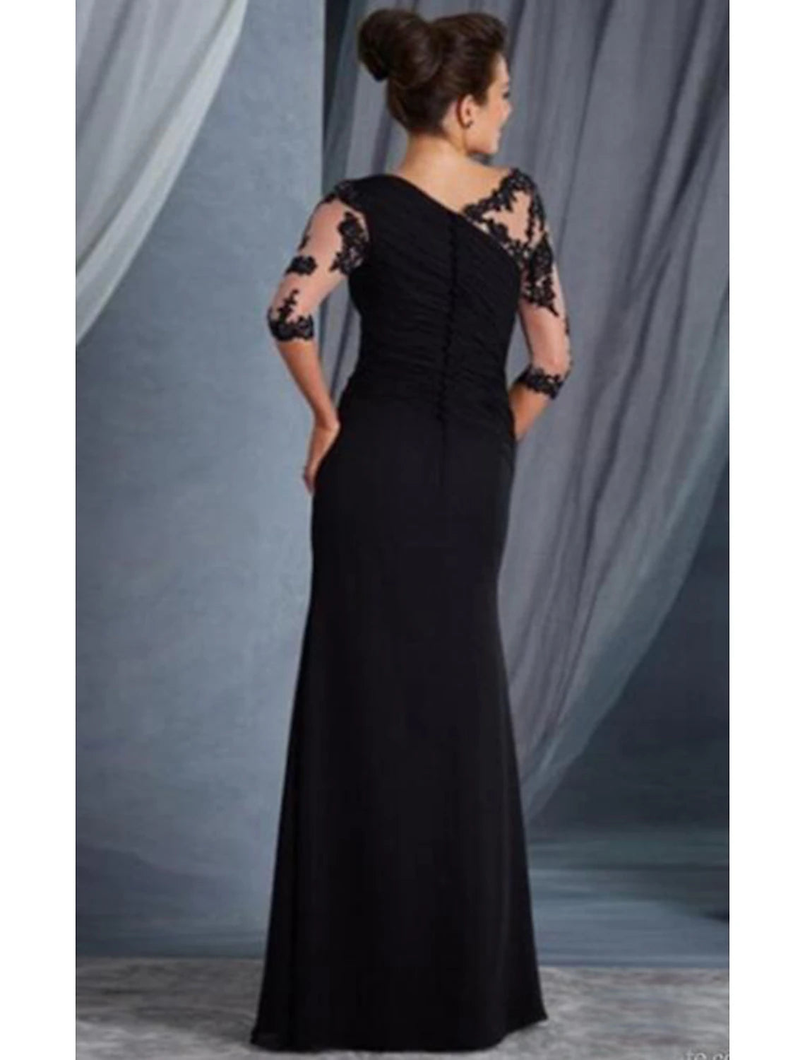 Back view of a woman in the Weitese black floor-length formal dress, highlighting the lace applique details.