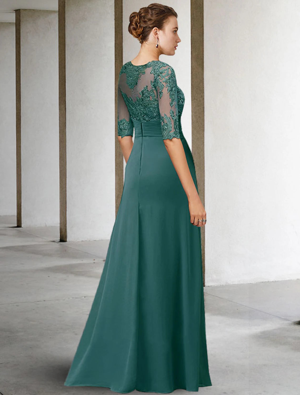 Close-up of the intricate lace and applique detail on the bodice of the blue sheath dress.