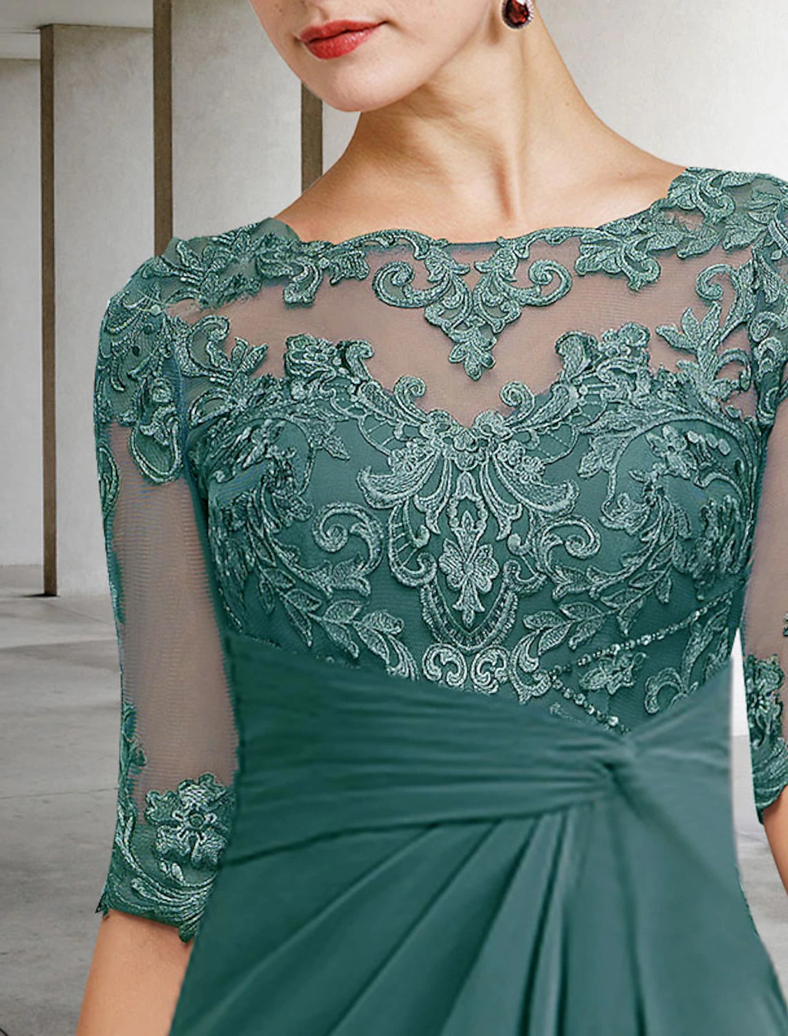 Side view of the blue draped chiffon and lace dress, highlighting the flattering silhouette.