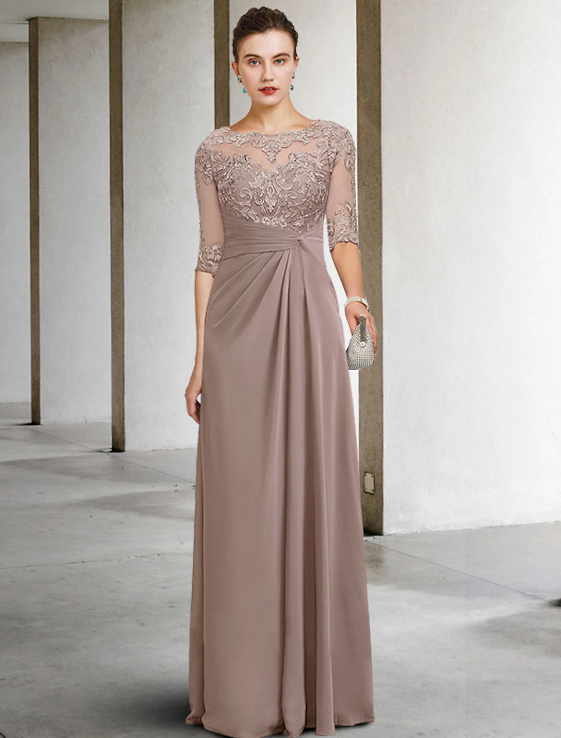 Model posing gracefully in the blue elegant dress, emphasizing the floor-length skirt.