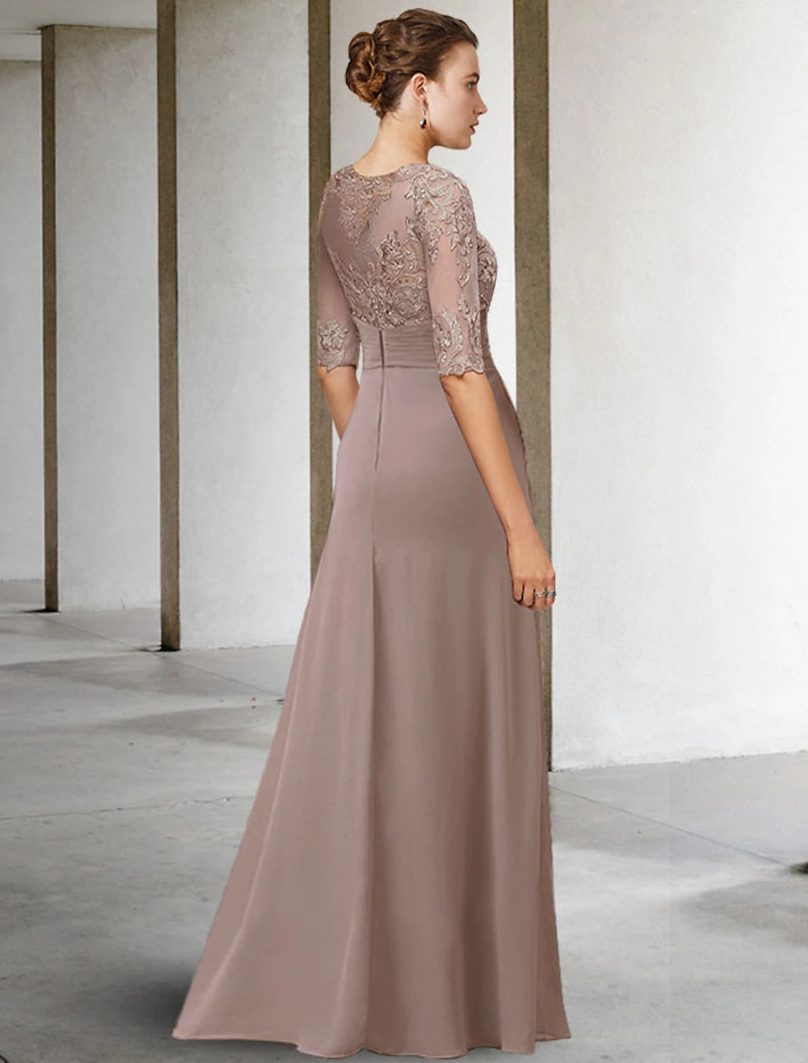 Detail of the short lace sleeves and sophisticated jewel neckline on the blue dress.