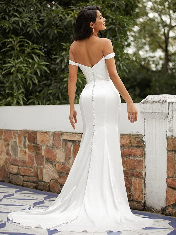 Back view of the sheath wedding dress, showcasing the sweep train and ruched satin fabric.