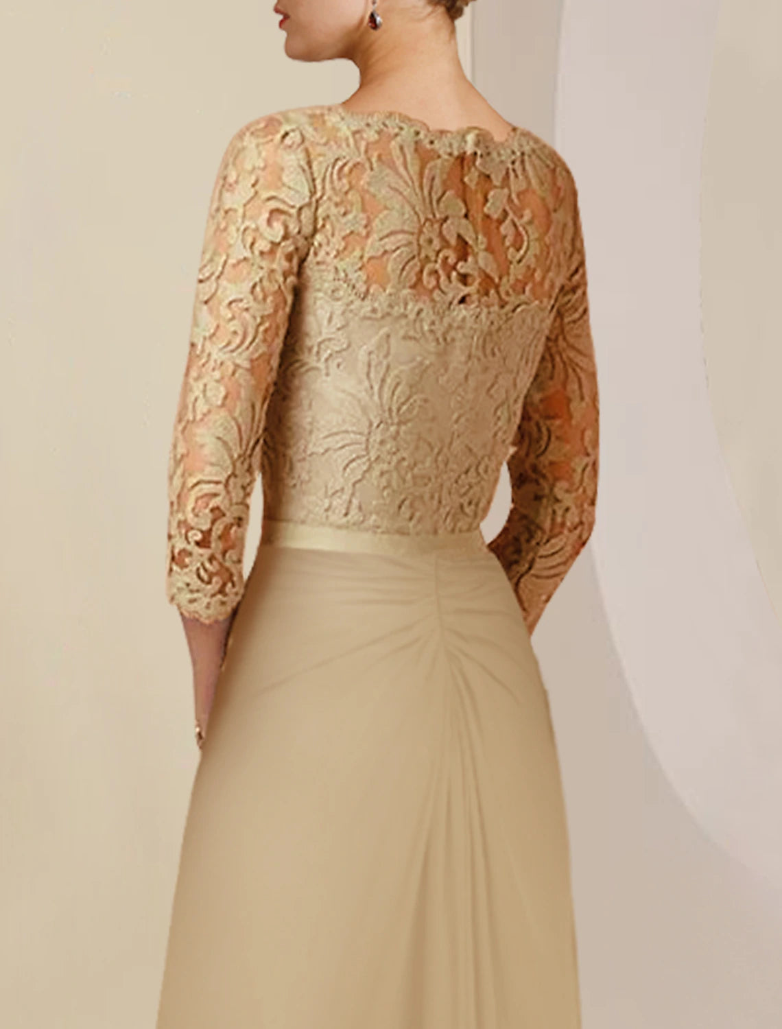 Back view of the formal wedding guest dress with applique and bow details.