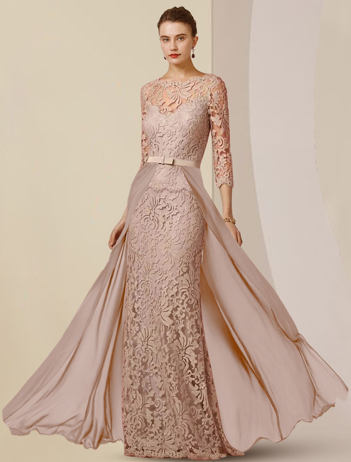 Detailed view of the chiffon and lace fabric with appliques and bows on the gown.