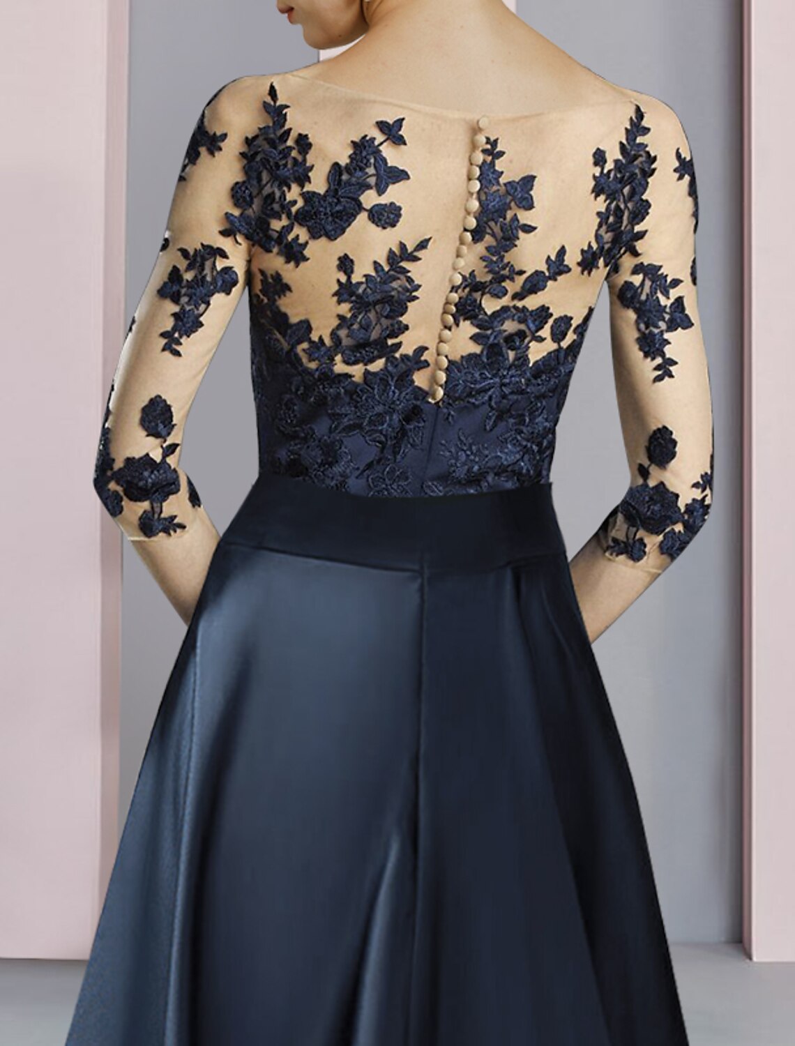 Detail of the satin lace fabric and bow embellishment on the Weitese dress.