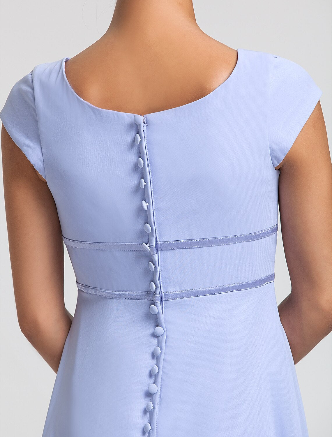 Close-up of the dress bodice, featuring the square neck and delicate short sleeves.
