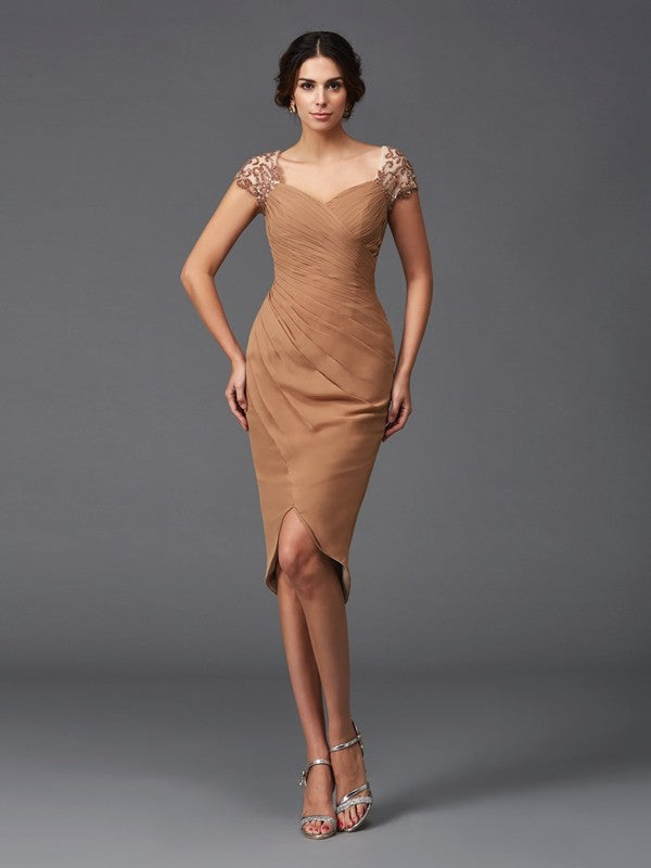 Full view of an elegant Mother of the Bride sheath dress with sweetheart neckline and high-low chiffon skirt.