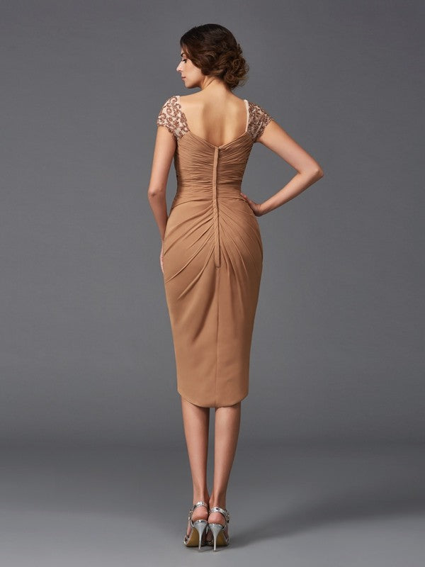 Side profile of the Mother of the Bride sheath dress, showing short sleeves and flowing chiffon.