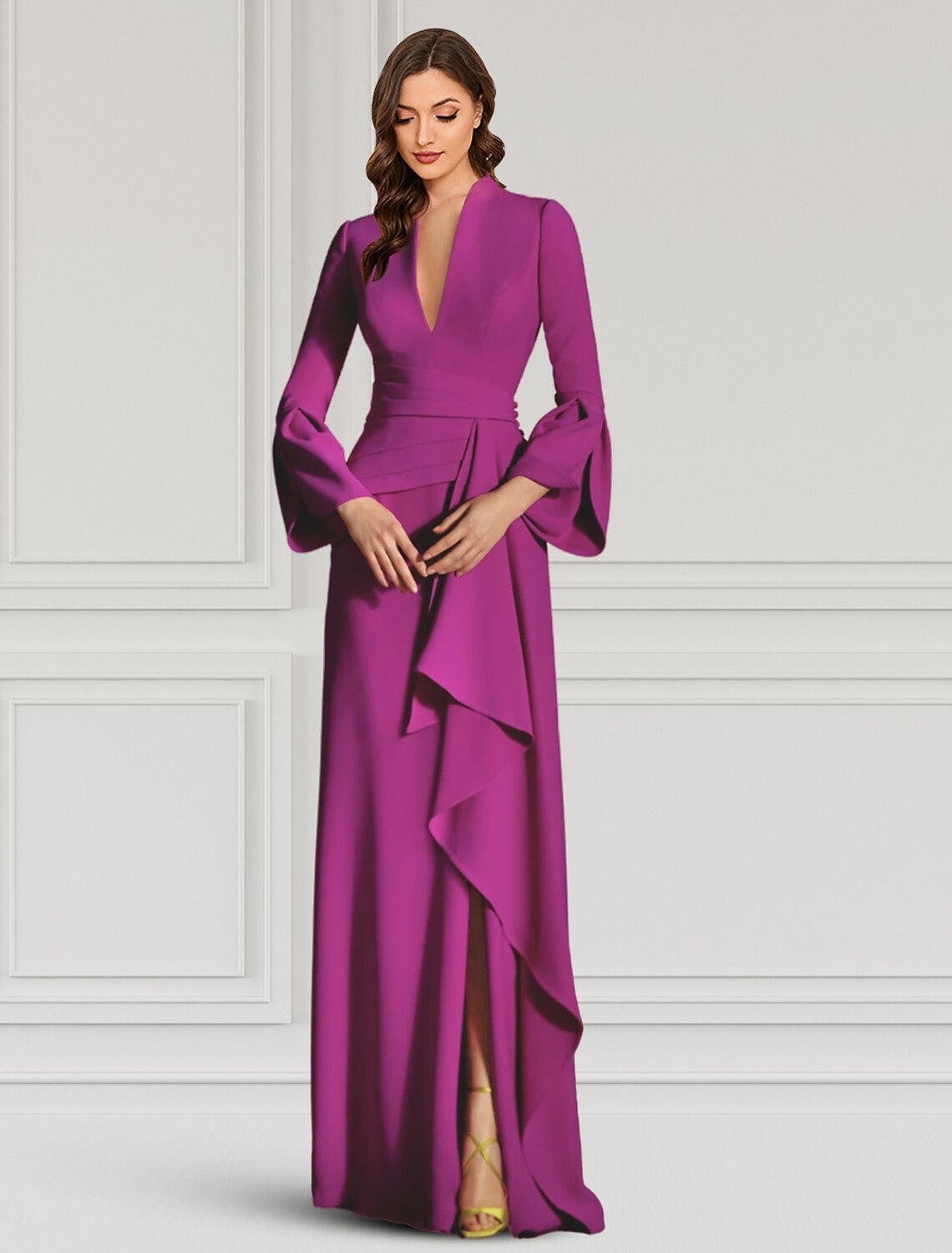 Woman wearing a black V-neck long sleeve sheath evening gown with ruffles.