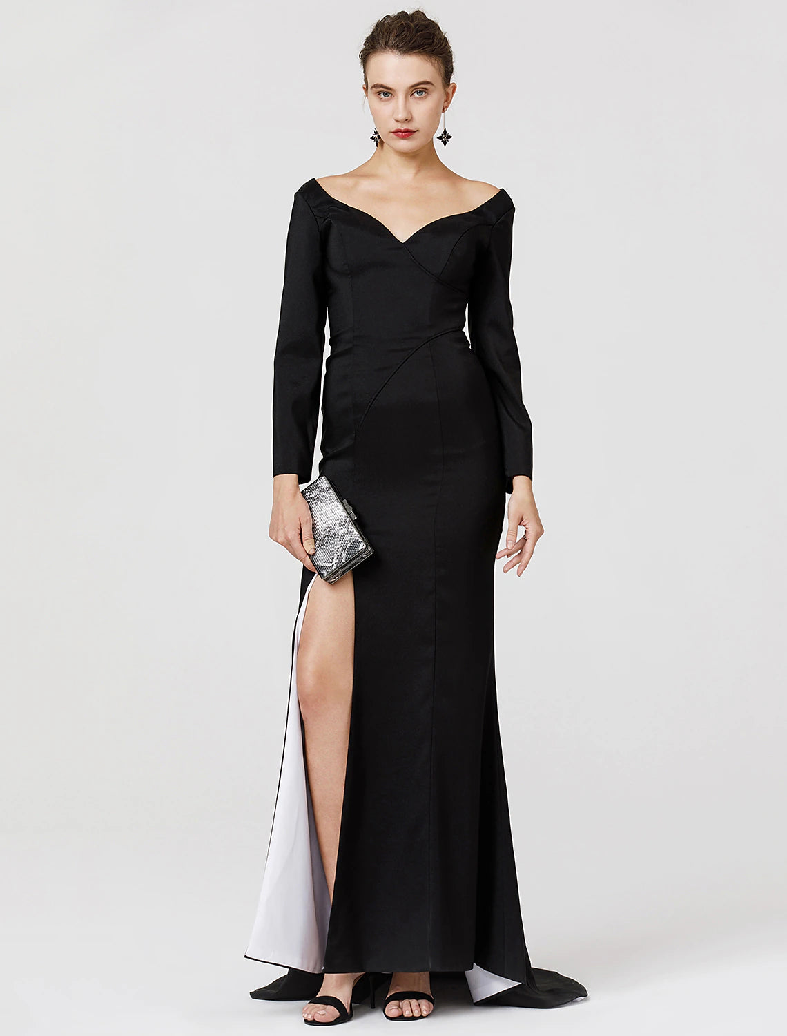 Close-up of the V-neckline and long sleeves of the dark stretch satin prom dress.