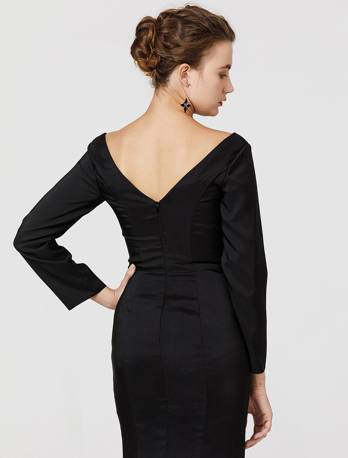 Full-length view of a woman in an elegant dark stretch satin prom dress.