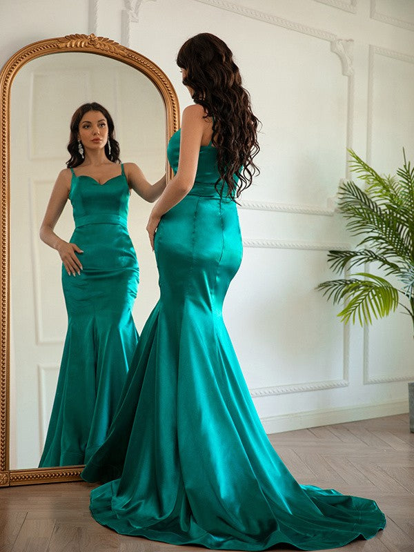 Back view of the elegant light-colored sheath prom dress, highlighting the sweep train.