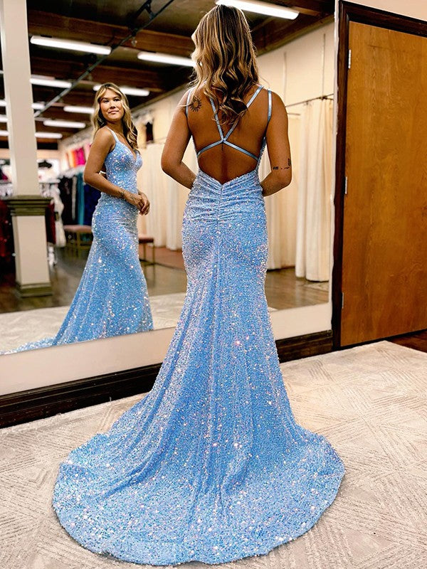 Side view of a model in a ruched velvet sequin formal gown.