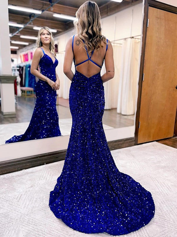 Back view of a model showcasing the sweep train of a sequined velvet dress.