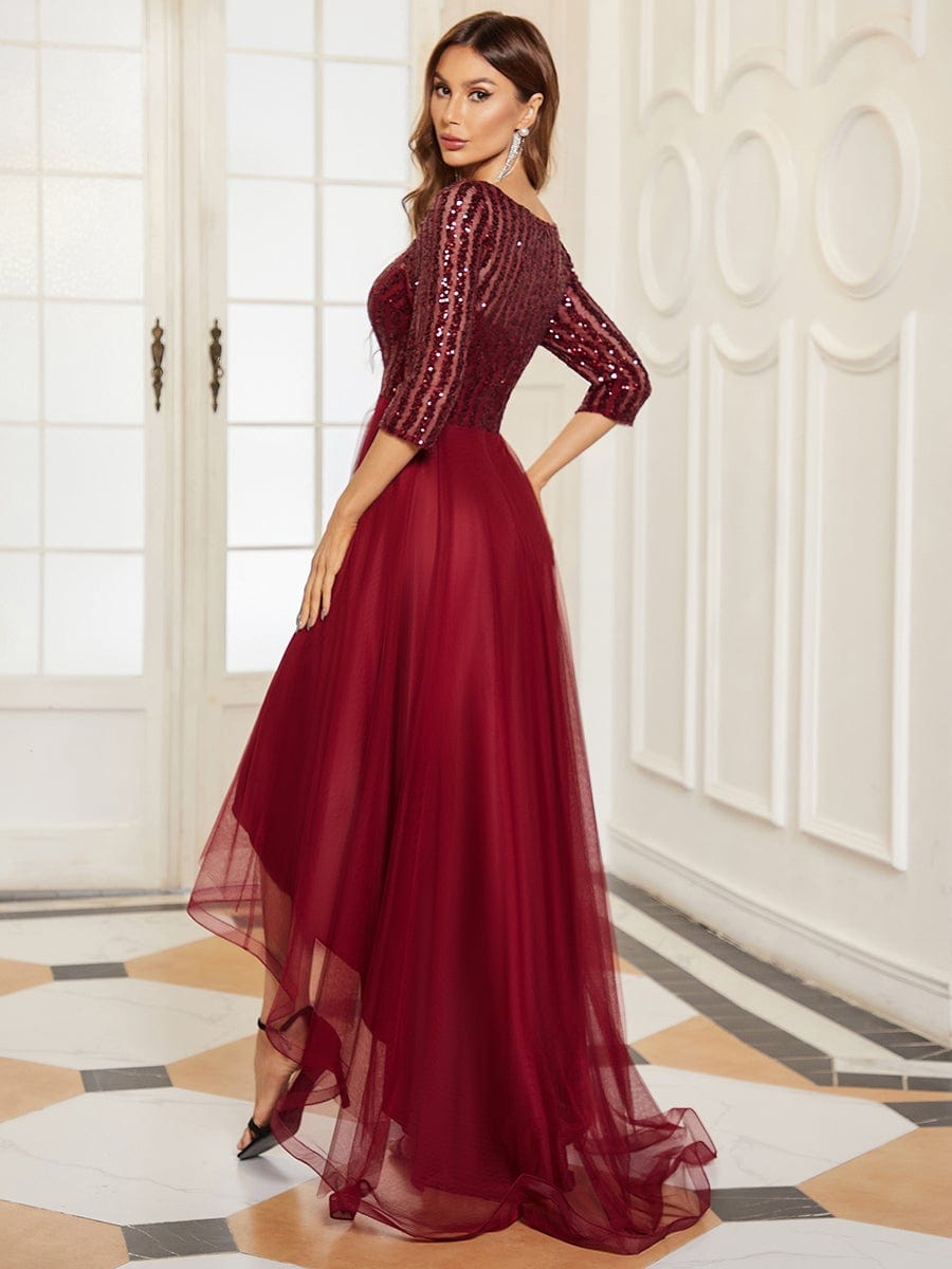 Side view of the red sheer sequin high-low dress, showing the flowing skirt.