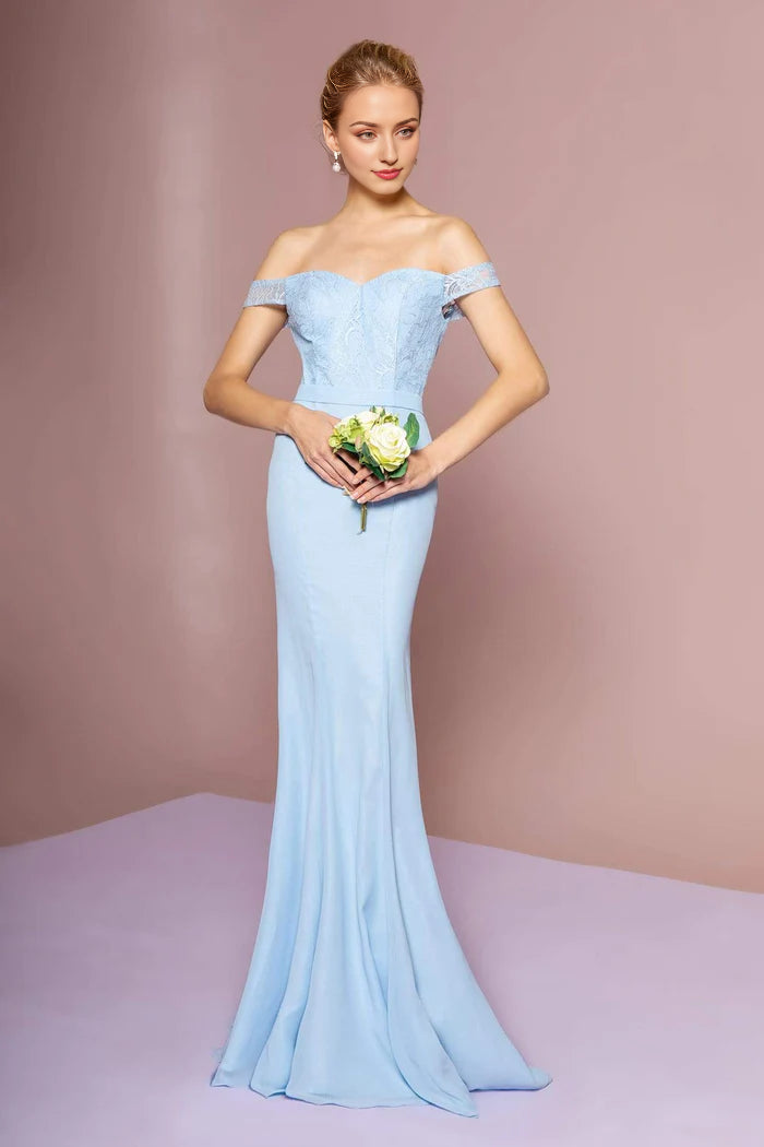 Full-length view of a woman in an elegant shoulder lace mermaid gown.