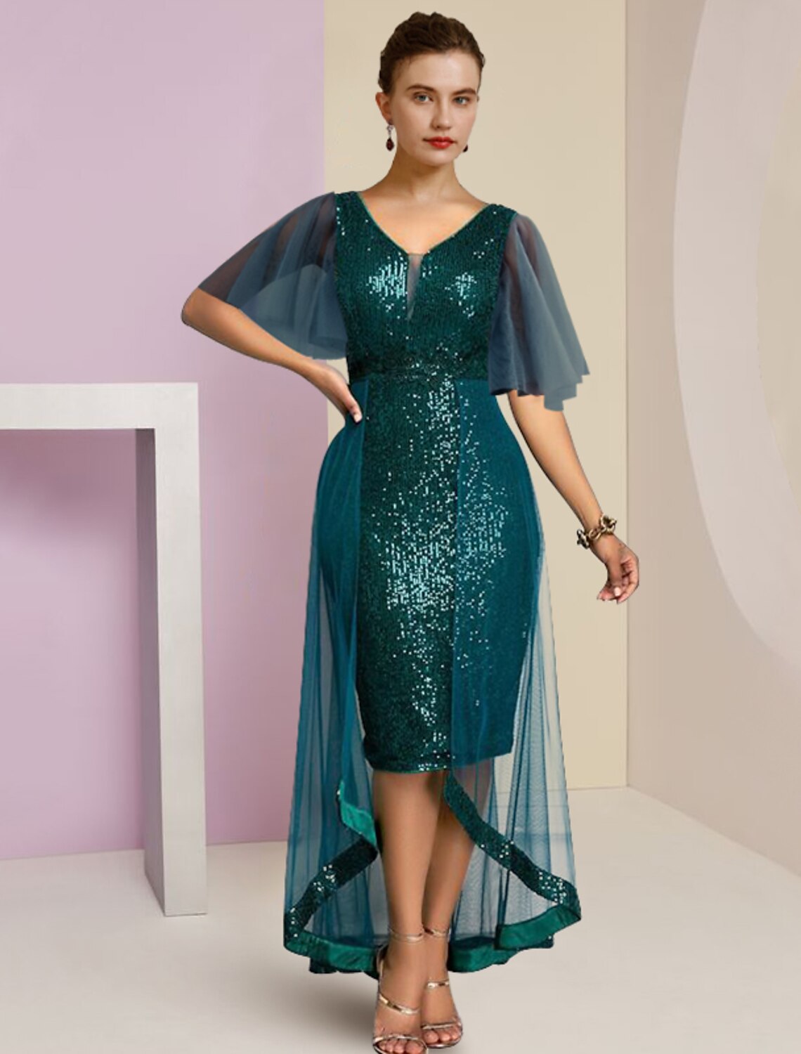 Woman wearing an elegant sequined chiffon V-neck short sleeve high-low dress.