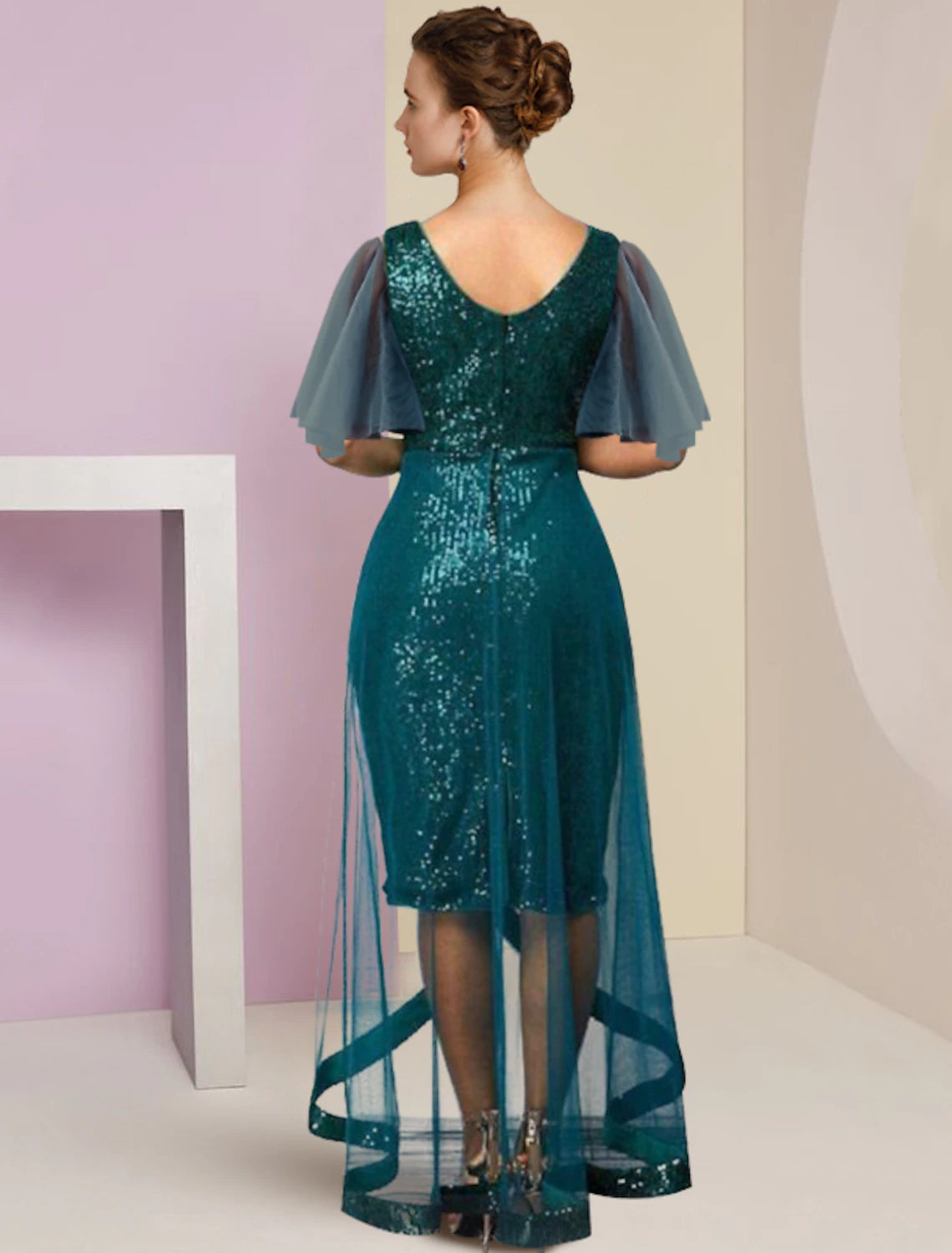 Side view of a woman in a sparkling sheath column dress with short sleeves.