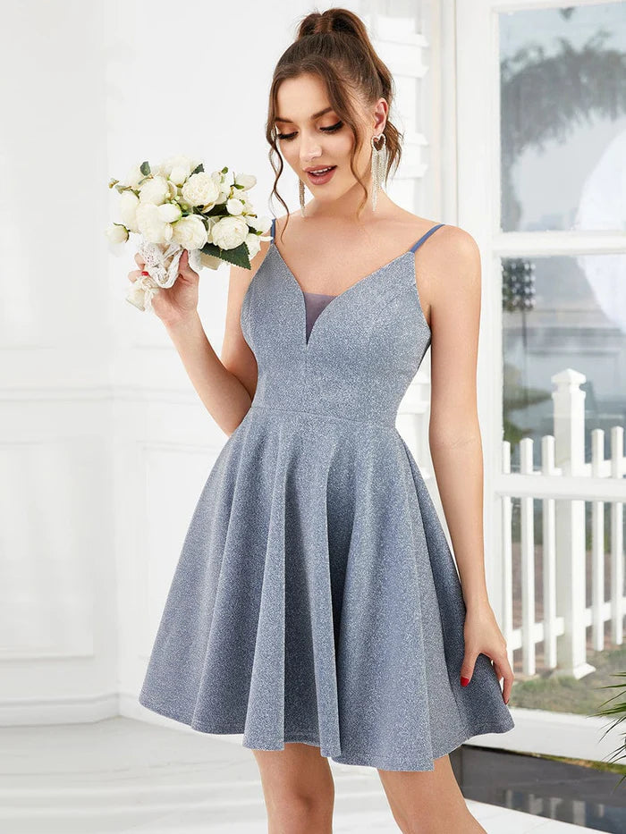 Woman in a sparkling homecoming dress with hands on hips.
