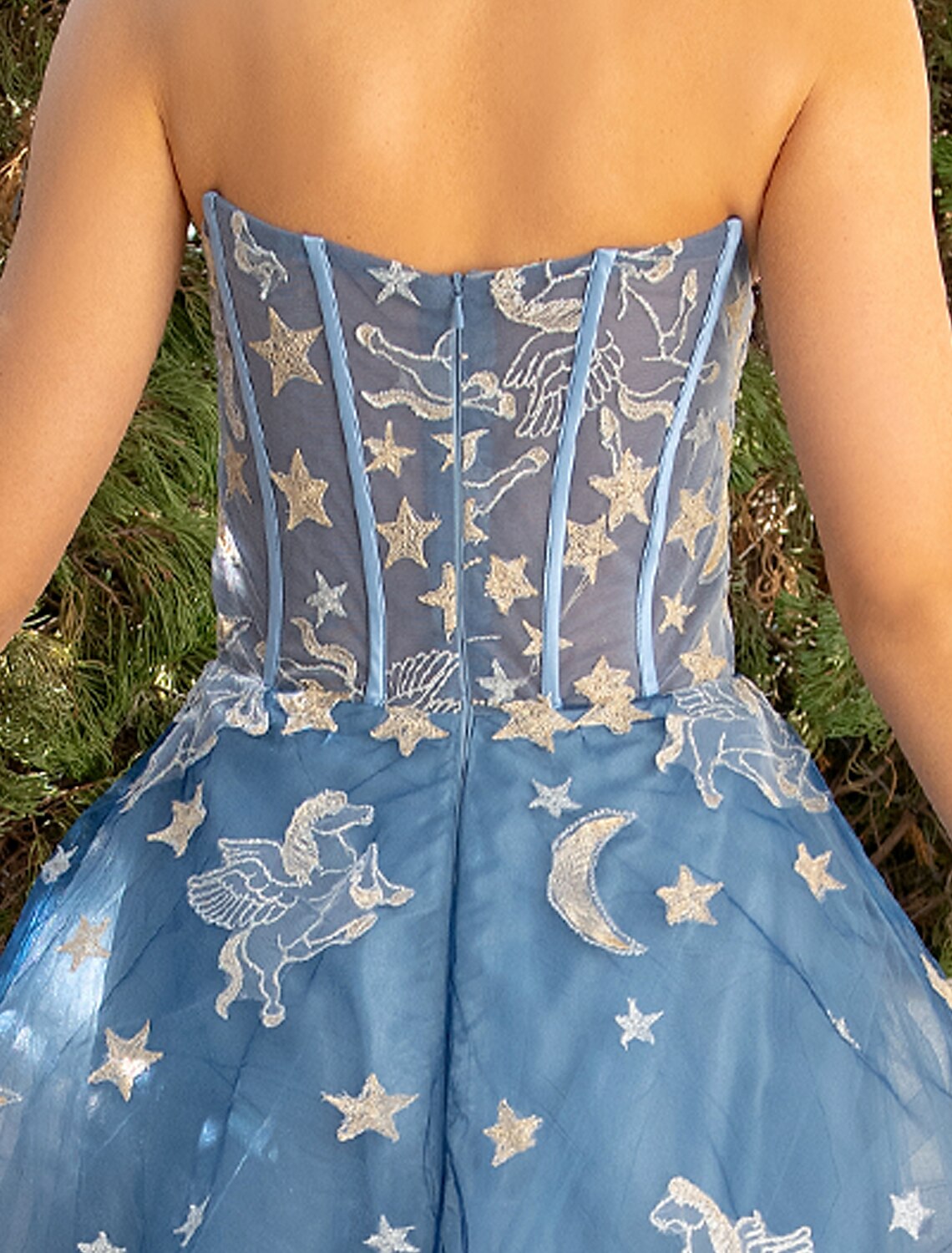 Model posing in the luxurious strapless ball gown.