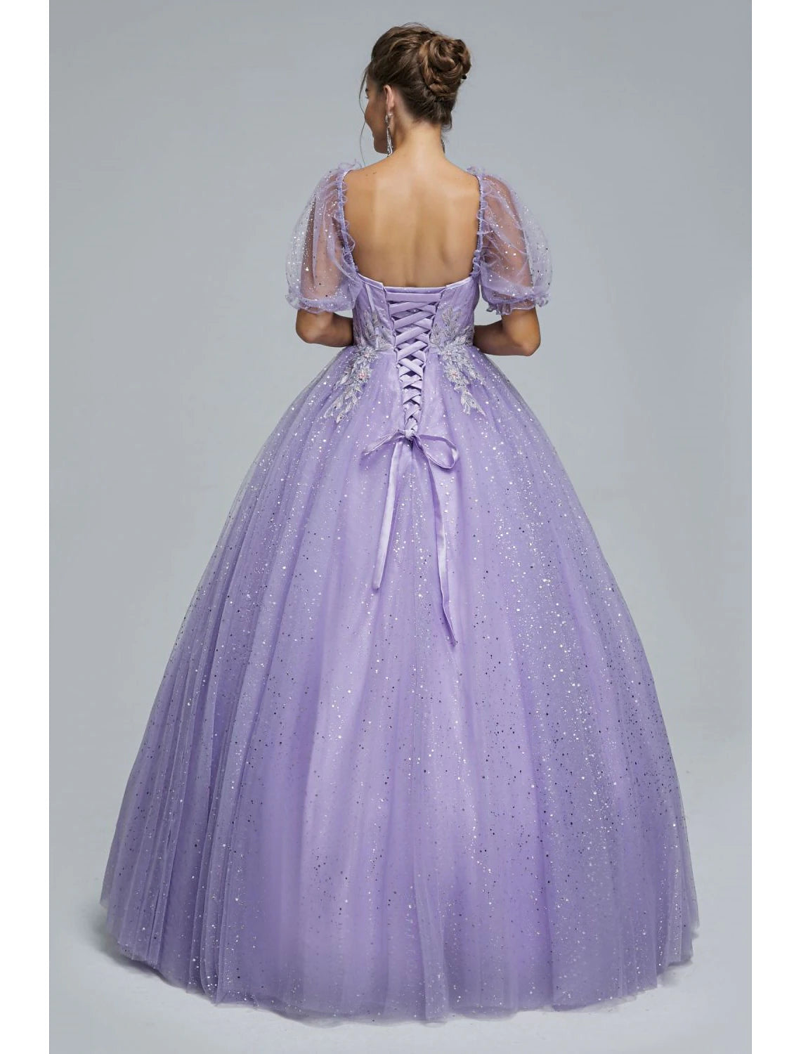 Close-up of the sweetheart neckline and short sleeves of the sequin tulle ball gown.