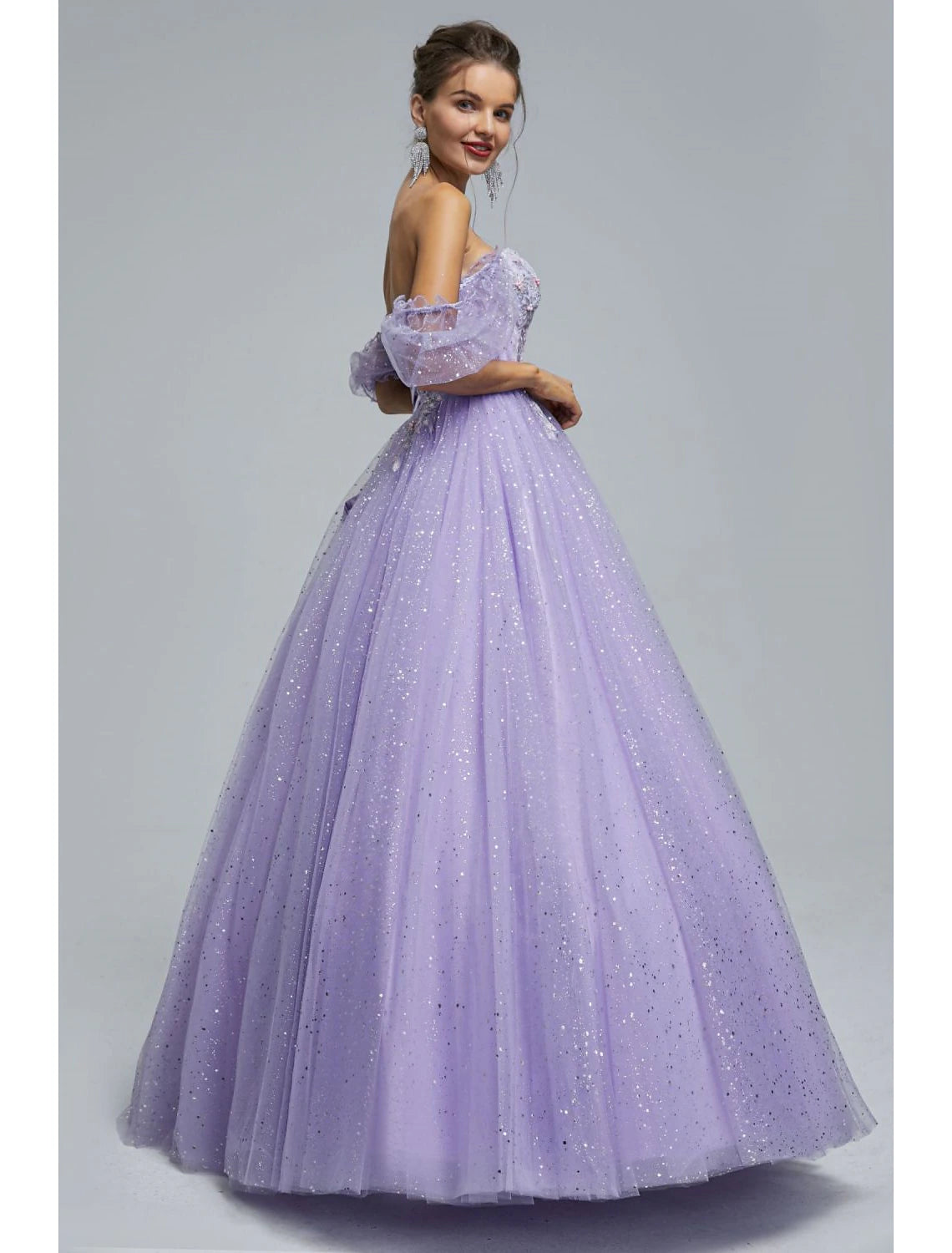 Back view of the floor-length ball gown, showcasing the full skirt and sequin details.