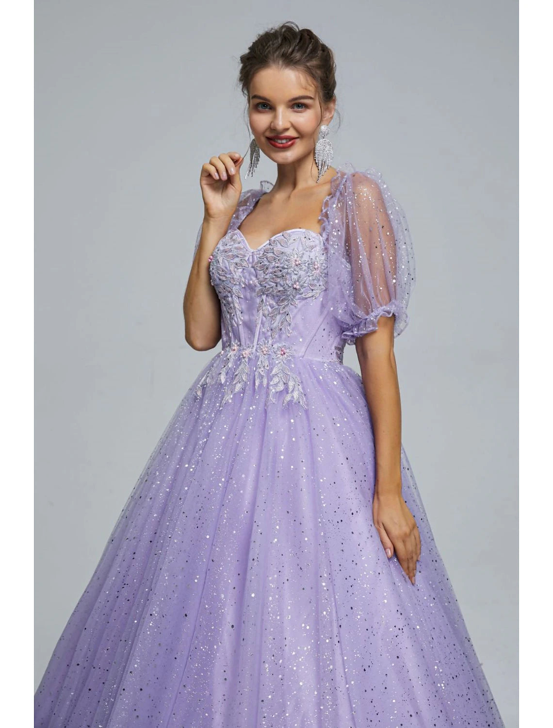 Side view of the elegant ball gown, highlighting the flowing tulle fabric.