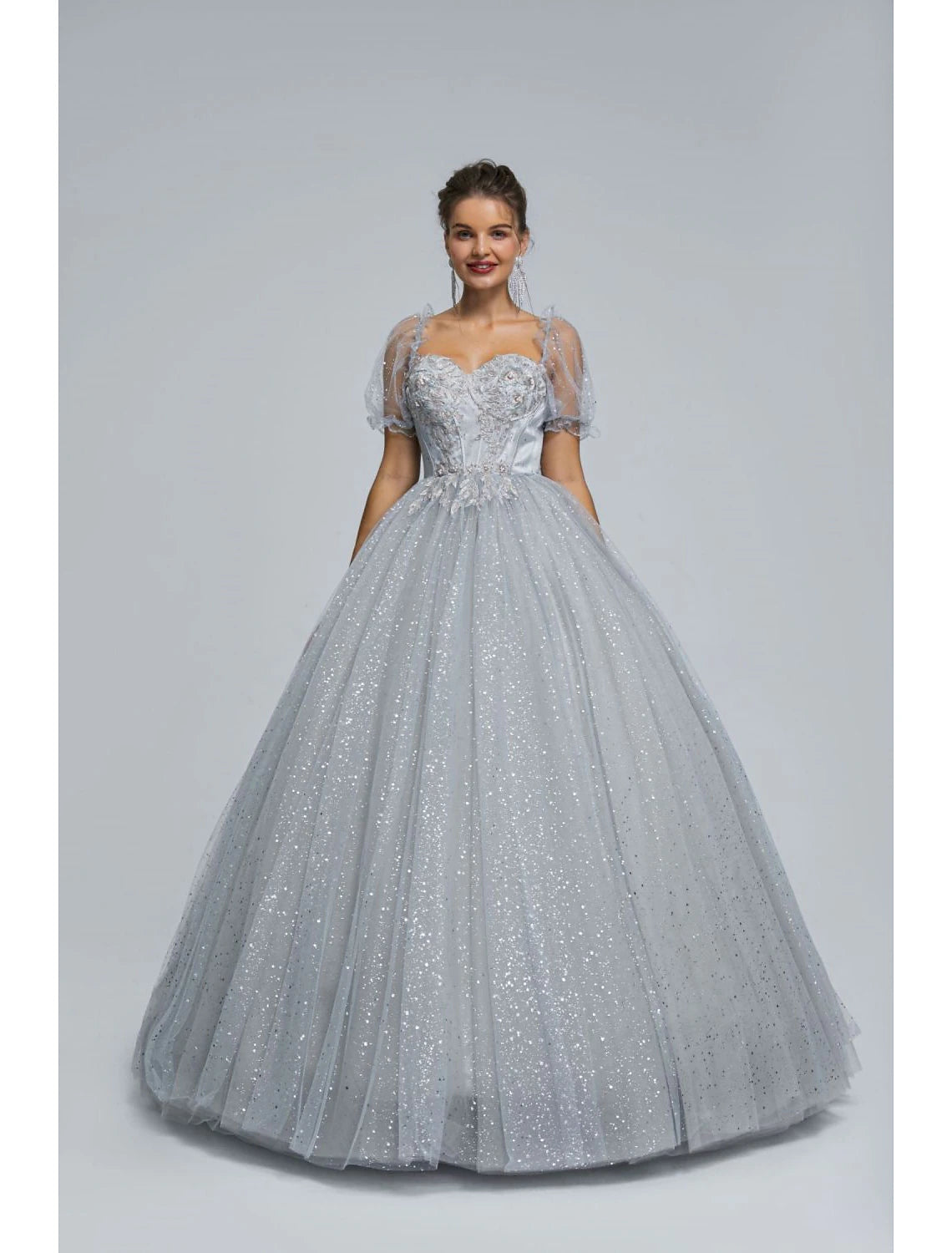 Woman posing in a shimmering ball gown, emphasizing the princess silhouette.