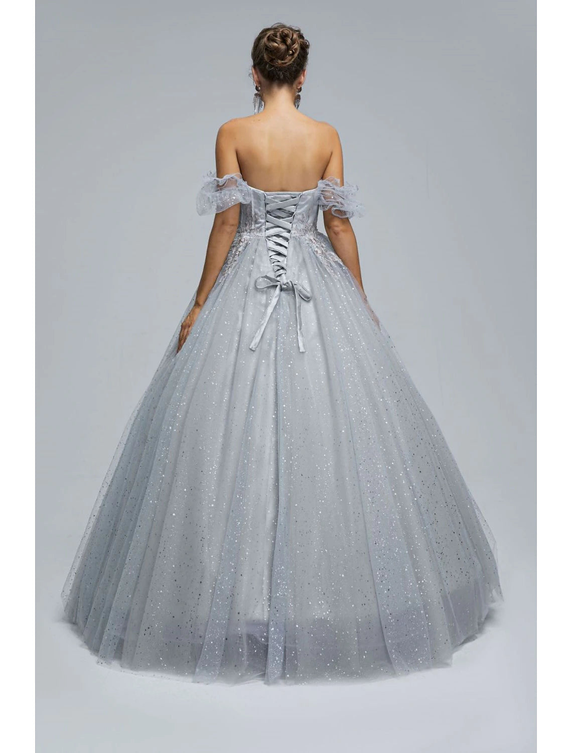 Detail of the sequin appliques on the tulle fabric of the ball gown.