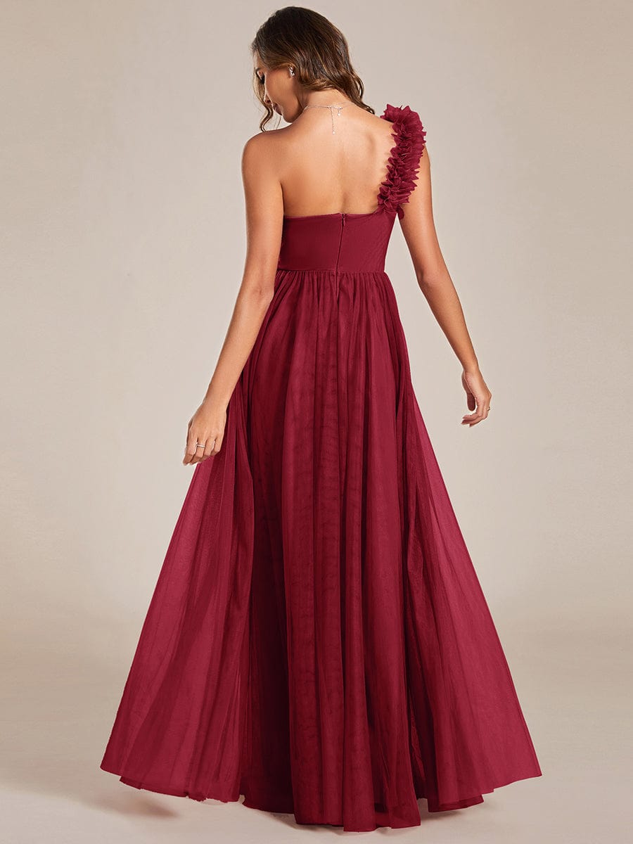Side view of a red Weitese bridesmaid dress, highlighting the high slit and flowing floral tulle.