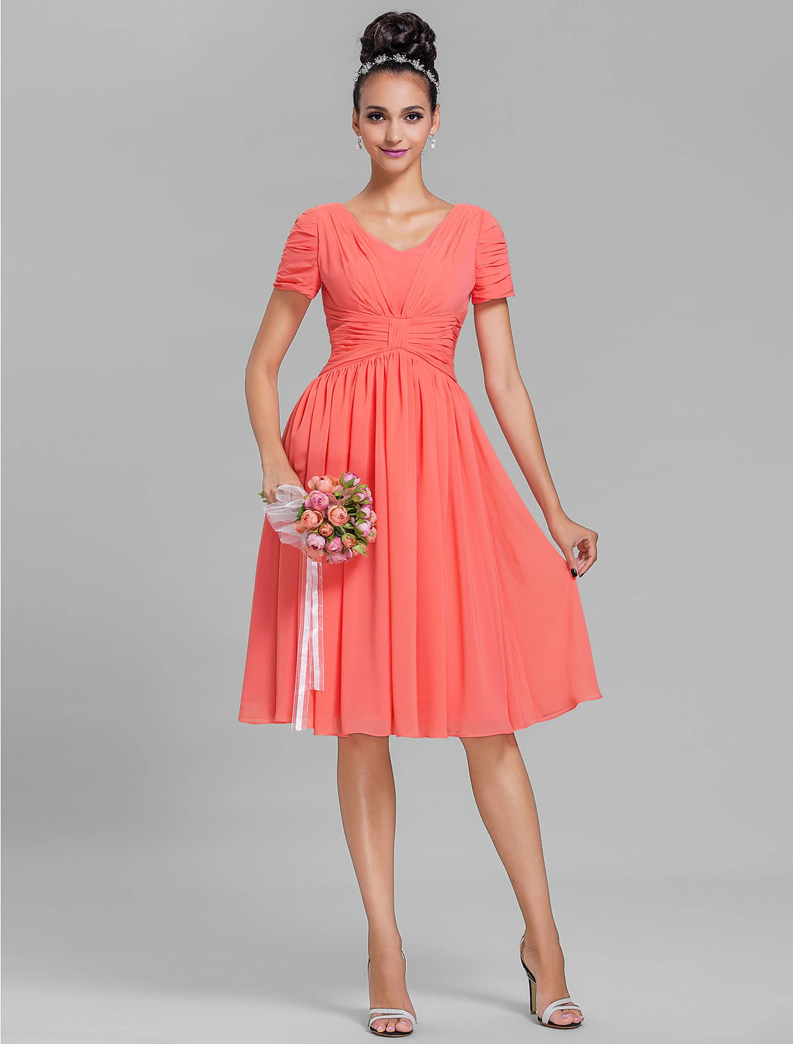 Model wearing a teal V-neck sheath bridesmaid dress with short sleeves and ruched details.