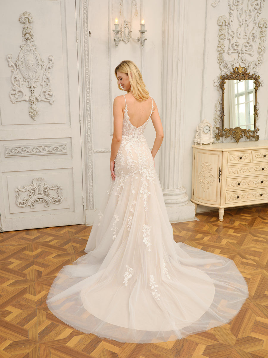 Side view of a bride wearing the trumpet mermaid wedding dress, showcasing its flowing silhouette.