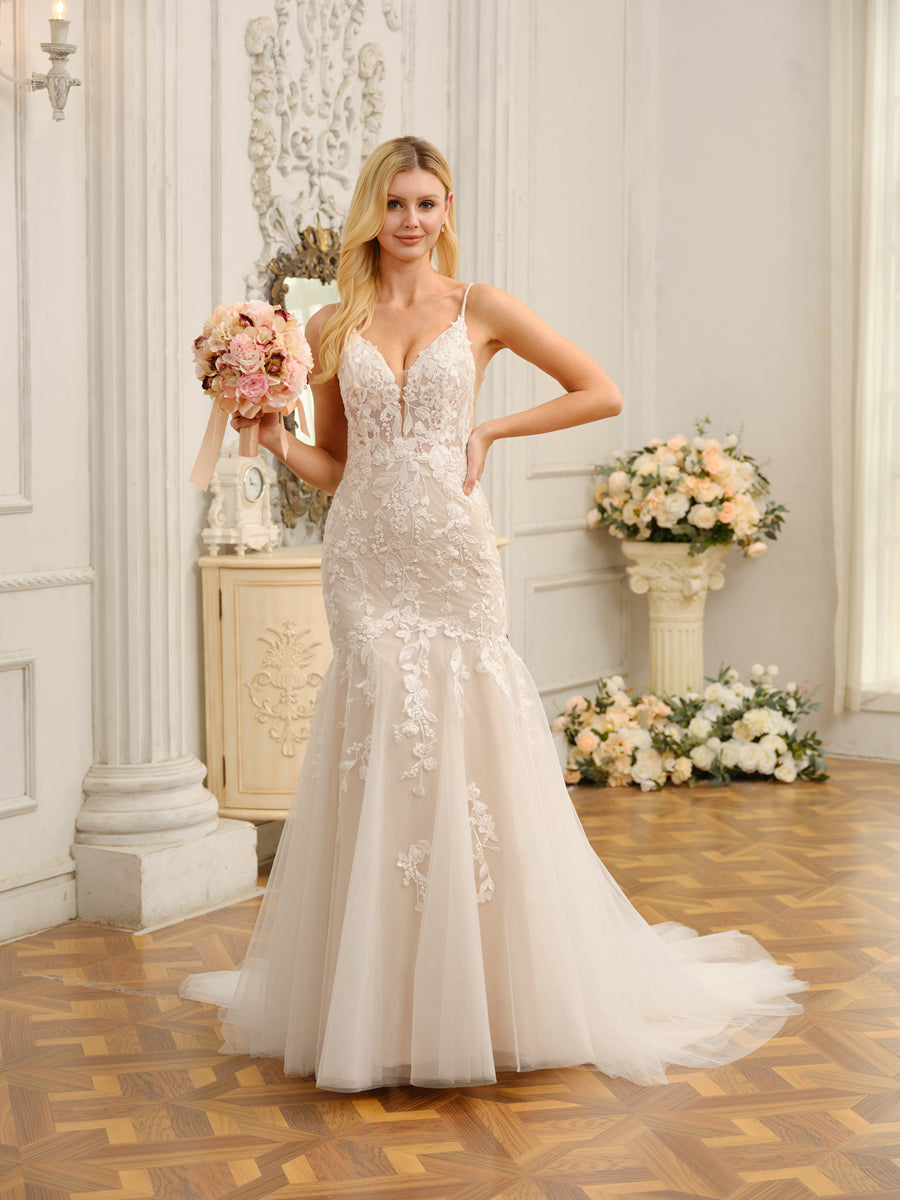 Back view of the long wedding dress, featuring a delicate train and detailed appliques.