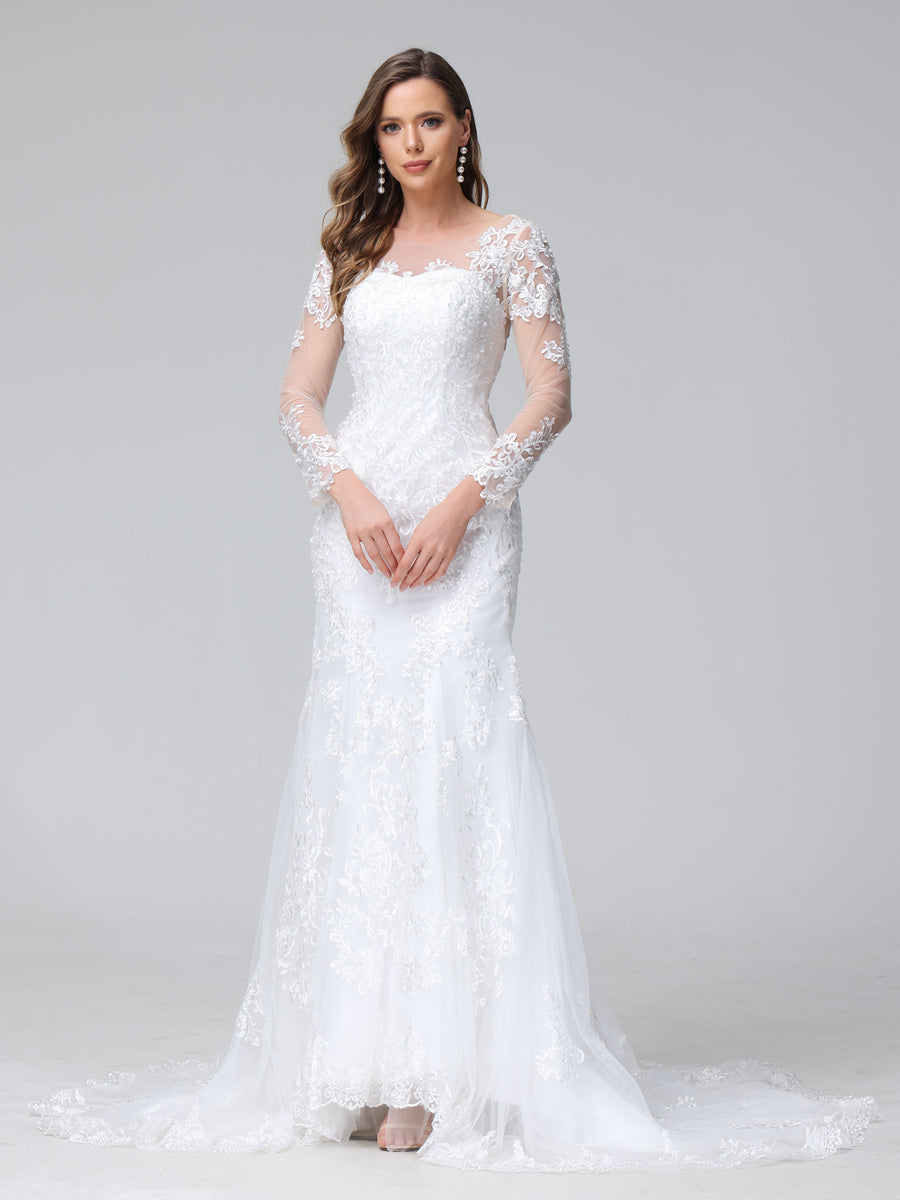 Full view of a bride in a white lace trumpet mermaid wedding dress with long sleeves and a sweetheart neckline.