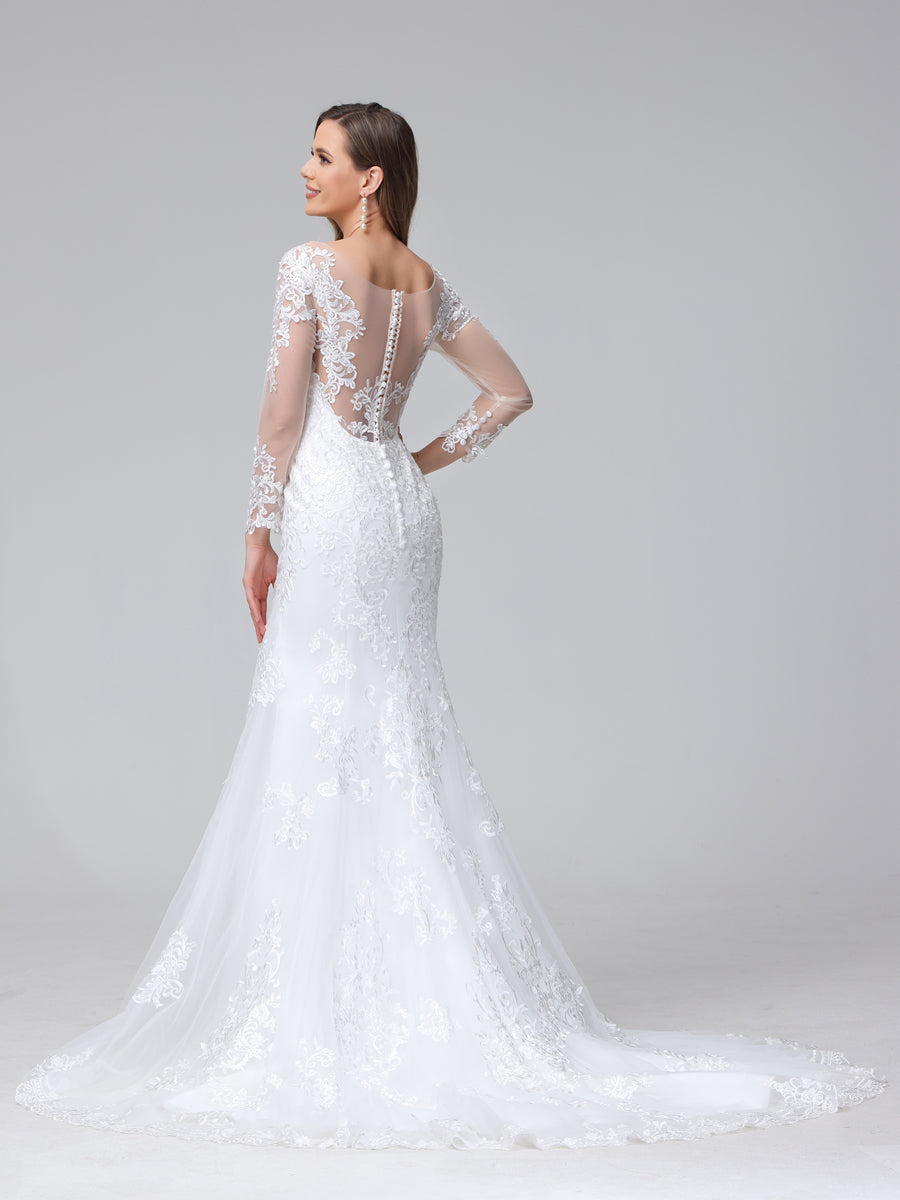 Side view of a bride in a white lace trumpet mermaid wedding dress, showing the long sleeves and train.