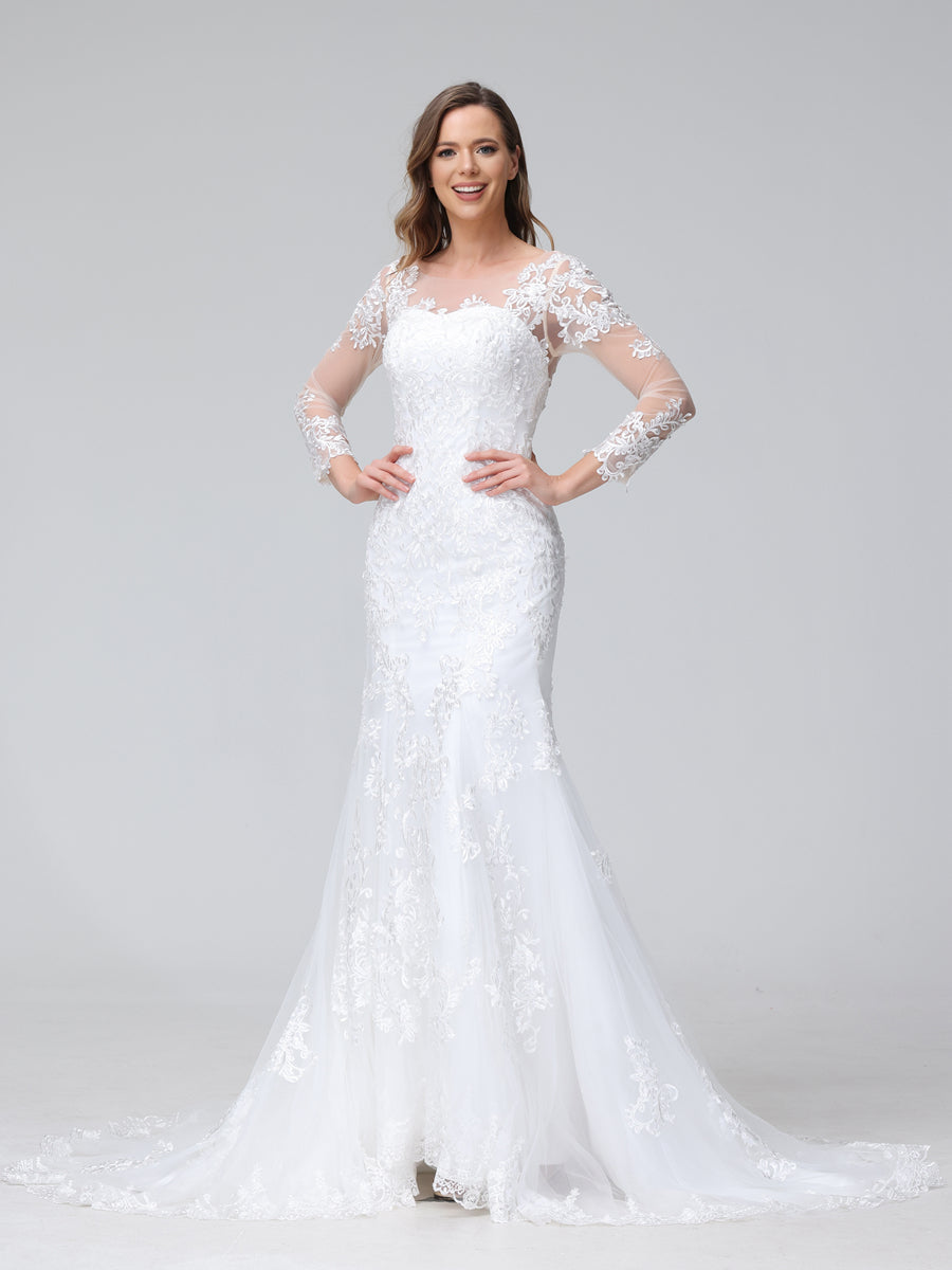 Front view of a bride in a white lace trumpet mermaid wedding dress, showcasing the sweetheart neckline and long sleeves.
