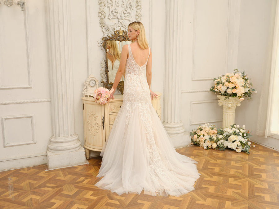 Back view of the white trumpet mermaid wedding dress, showing appliques and train.