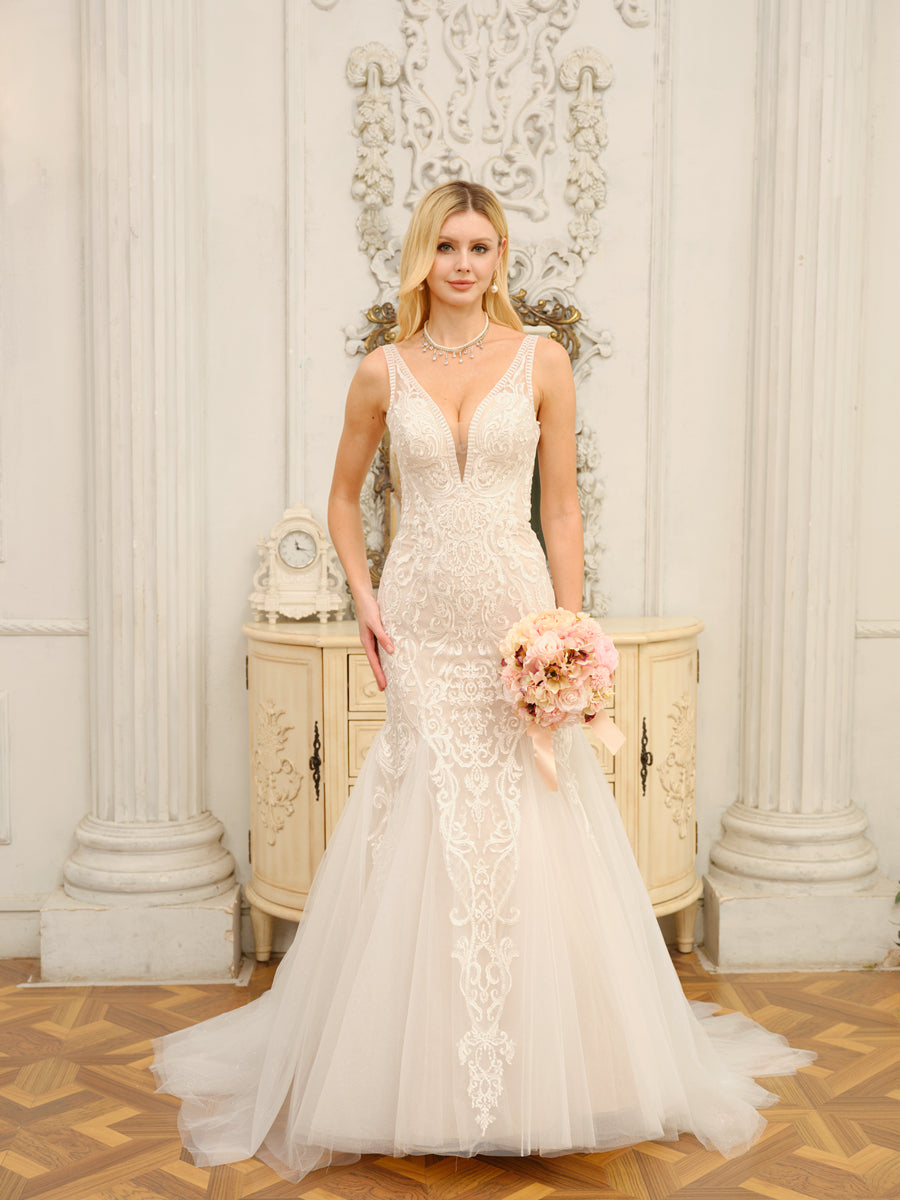 Side view of a model in the white trumpet mermaid wedding dress, highlighting the silhouette.