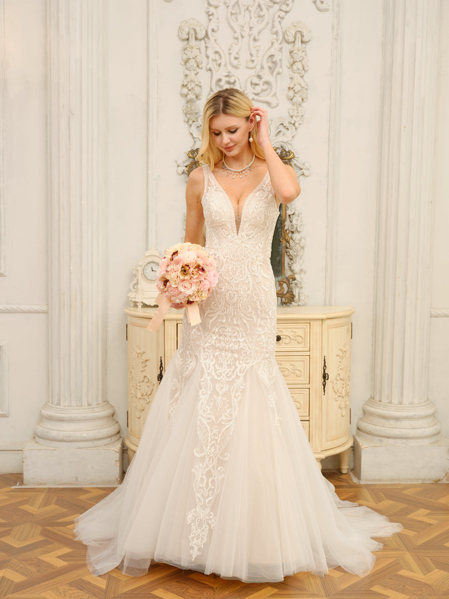 Model posing elegantly in the white trumpet mermaid wedding dress.