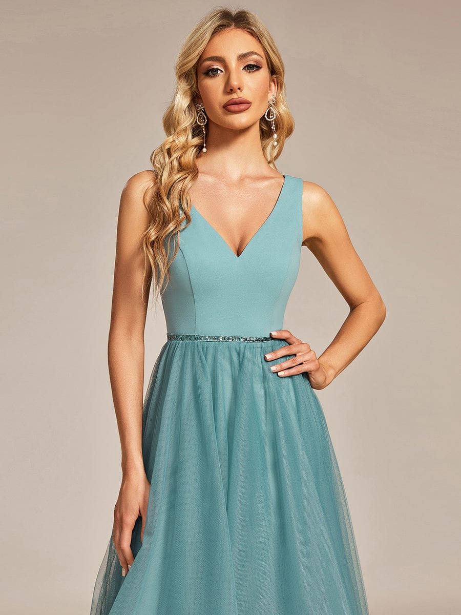 Detailed view of the waist chain and flowing tulle fabric on the prom dress.