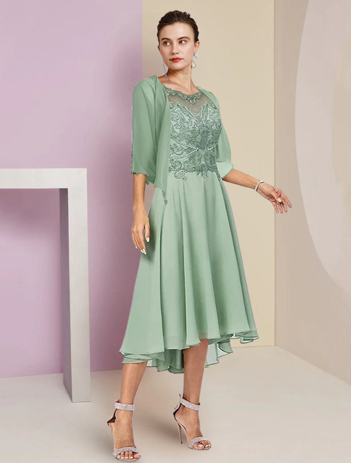 Elegant two-piece A-line mother of the bride dress with half sleeves and tea length skirt.