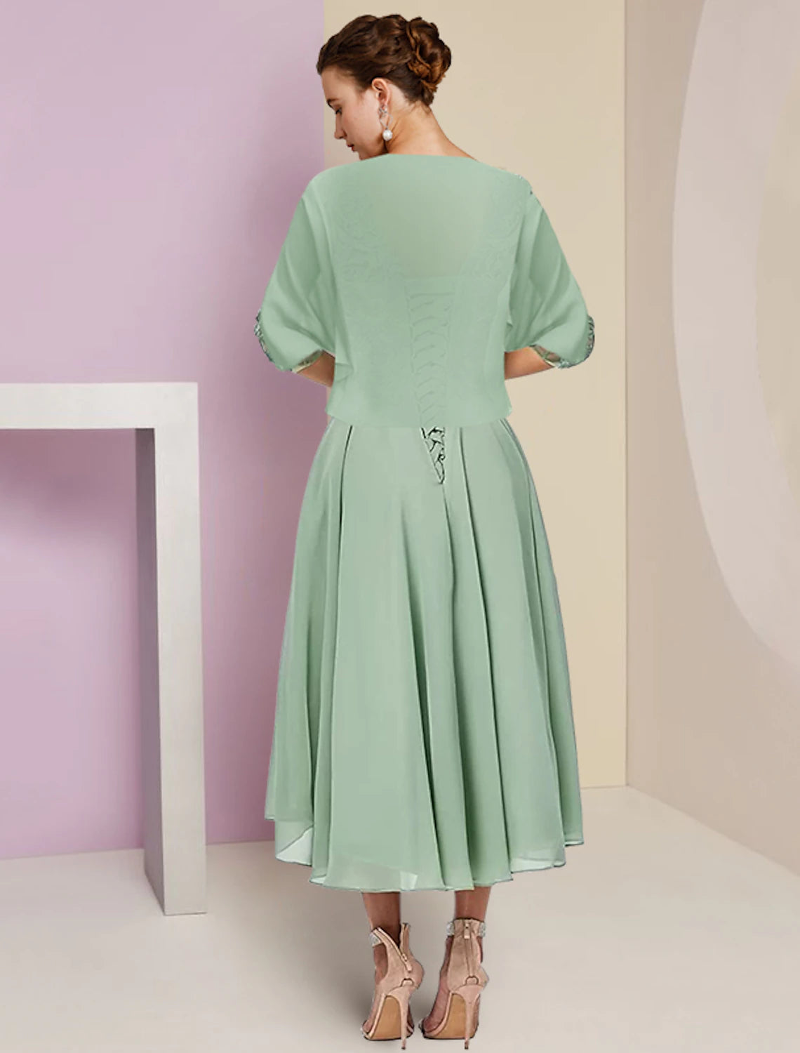 Side view of the A-line chiffon lace dress showing high-low hem and beading.