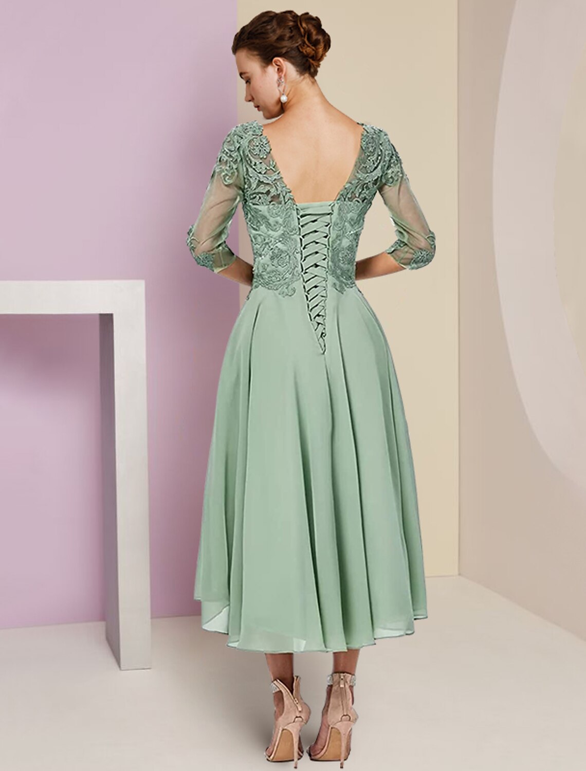 Full length view of the elegant A-line tea length dress.
