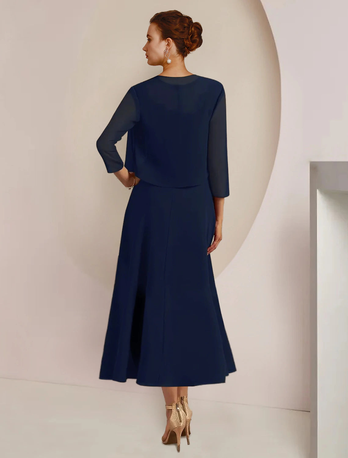 Back view of the two-piece A-line chiffon lace dress with a zipper closure.