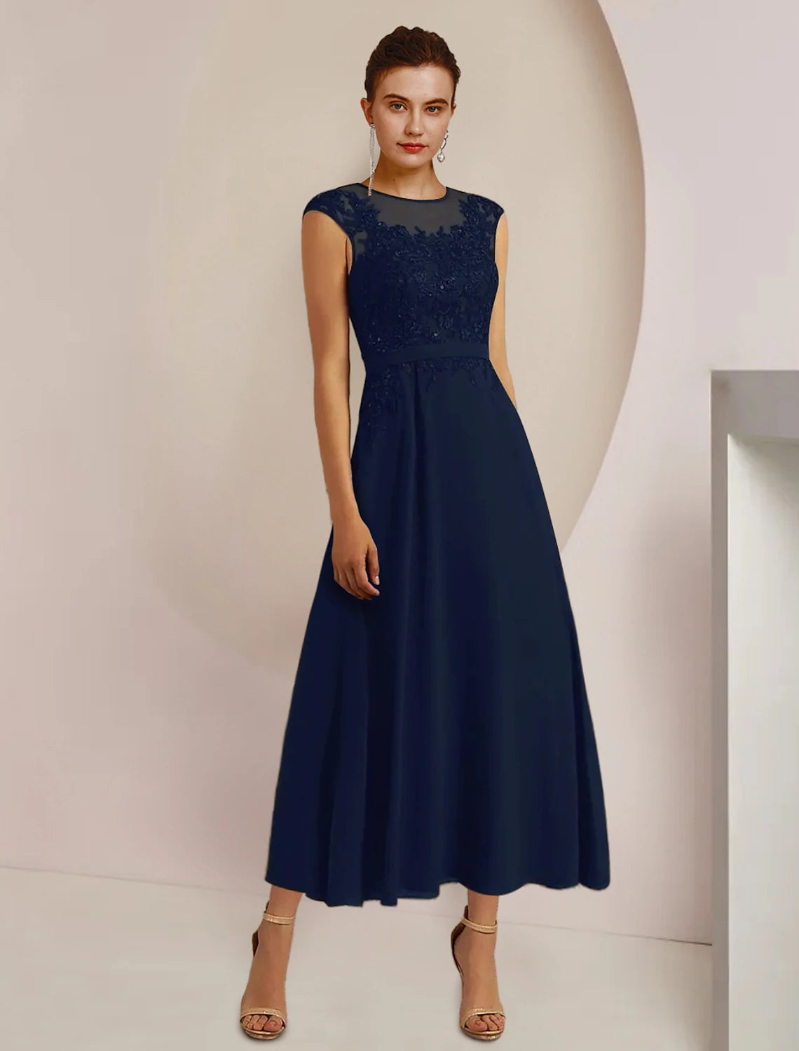 Side view of the tea-length mother of the bride dress featuring a lace jacket and sash appliques.