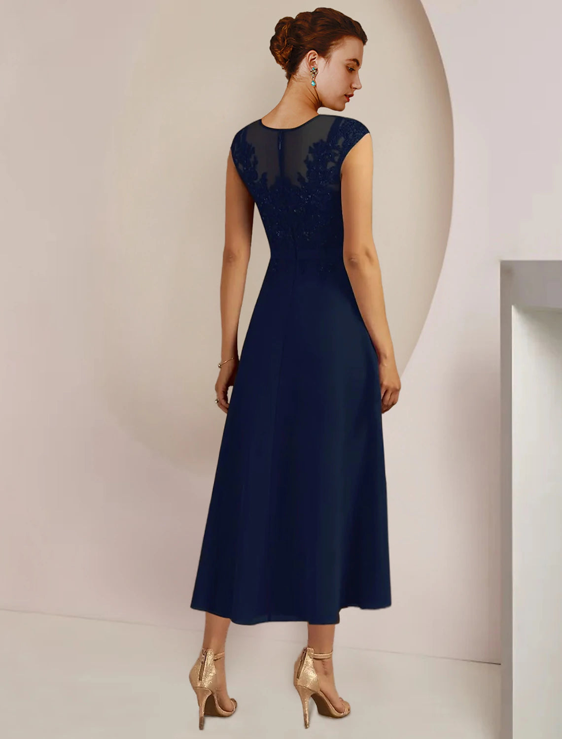 Close-up of the scoop neck and lace 3/4 sleeve jacket on the formal two-piece dress.